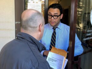 Activists staged a protest outside the office of Speaker Coughlin.