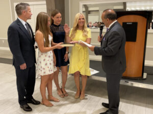 Hanlon assumes the oath of office.